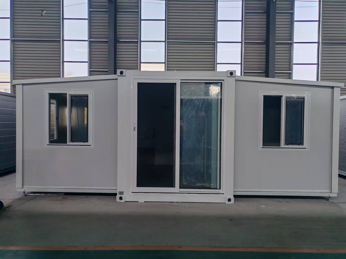 Folded HuoSheng container house modules stacked inside the factory before dispatch