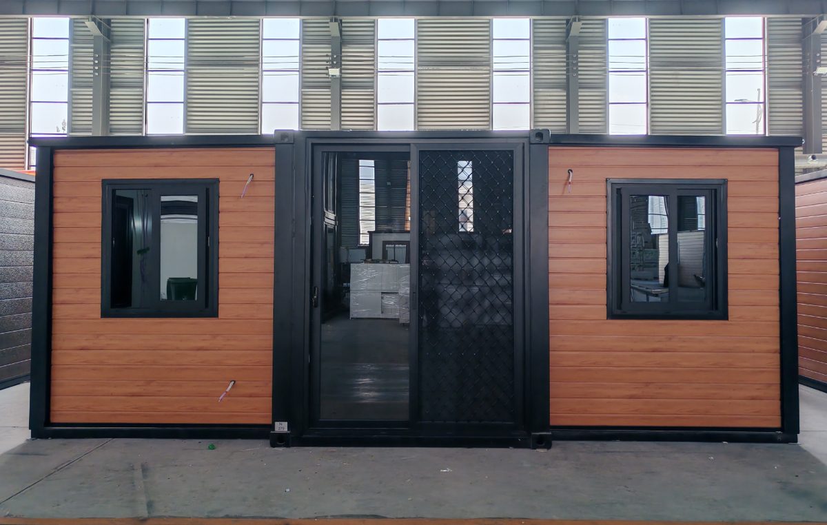 Expanded double-wing container house with wood-grain metal carved panels and black window frames